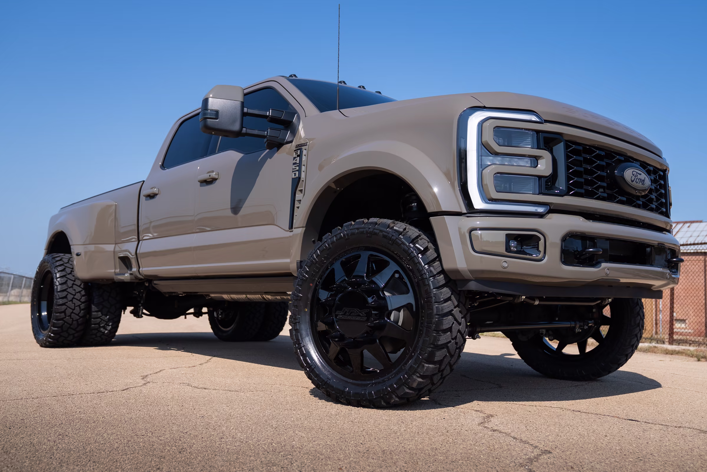 Low front view showing the lifted stance and black wheel fitment