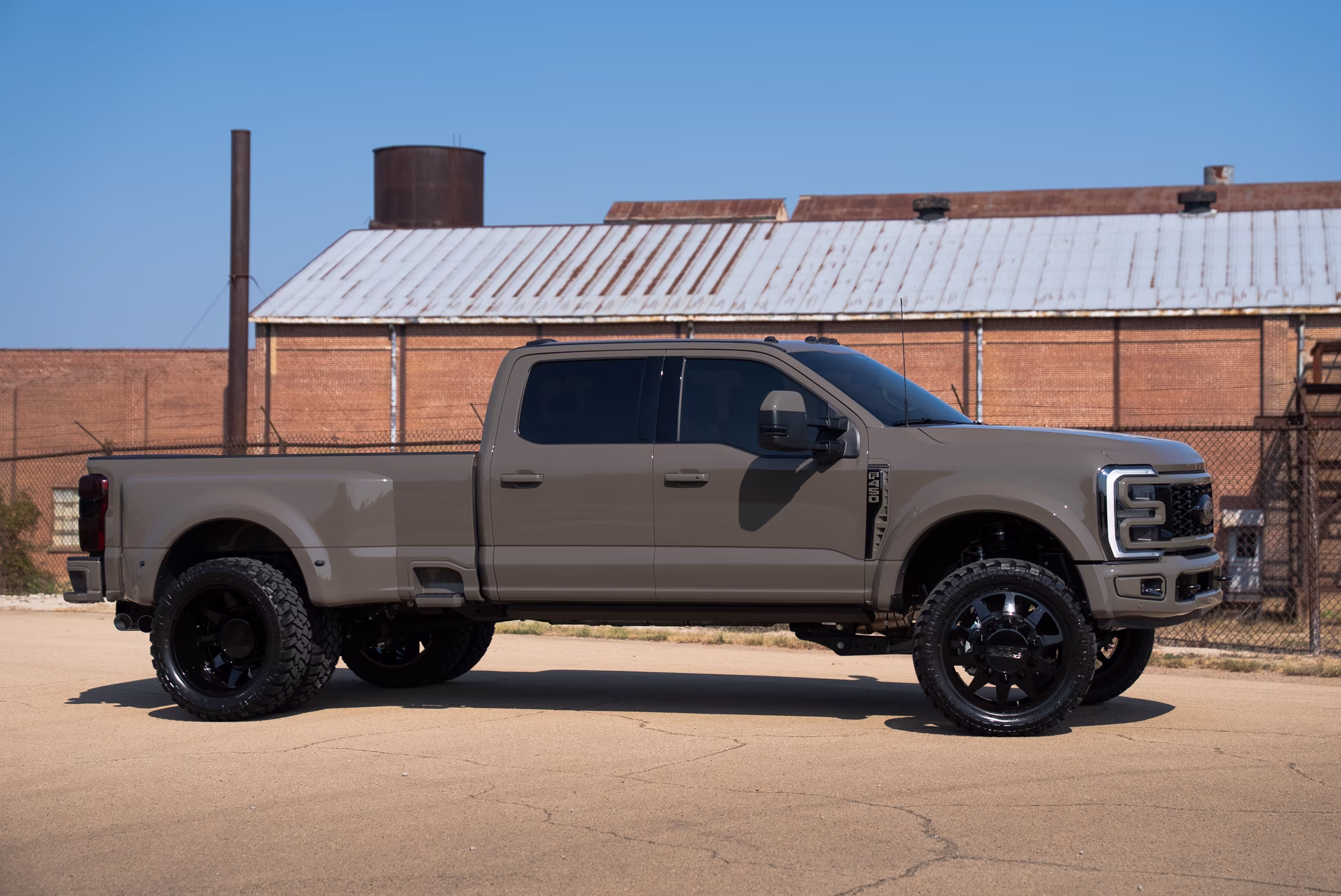 Full side profile of the lifted Marsh Gray Ford F-450 Platinum dually
